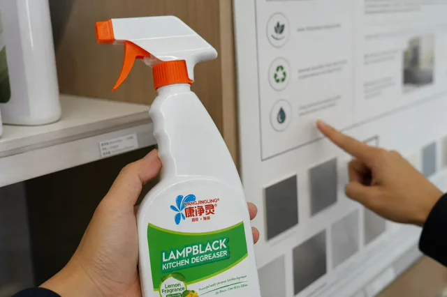 Qiaoshou grease remover bottle on a QC bench with label artwork notes, evidence folders and packaging review sheets for green claim review